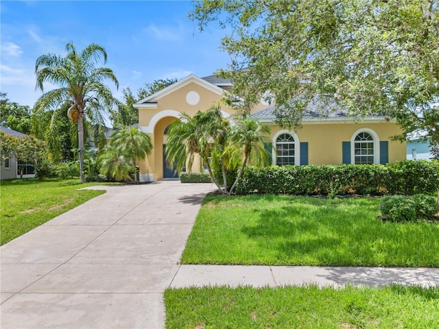 mediterranean / spanish-style home with a front yard