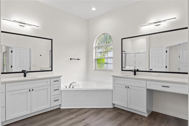 bathroom with vanity, independent shower and bath, and hardwood / wood-style flooring