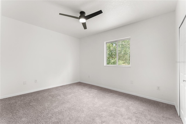 unfurnished room featuring carpet floors and ceiling fan