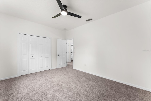 unfurnished bedroom with carpet flooring, ceiling fan, and a closet