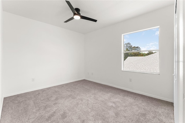 spare room featuring carpet and ceiling fan