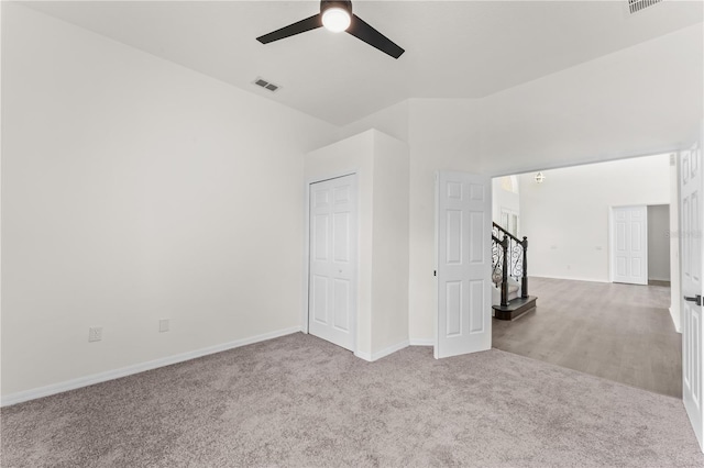 spare room with light carpet and ceiling fan