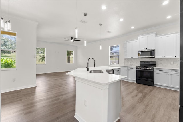 kitchen with black range with gas cooktop, ceiling fan, sink, decorative light fixtures, and white cabinets