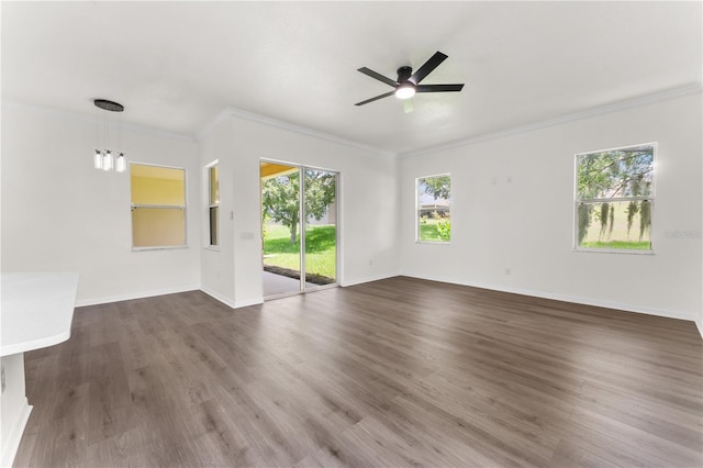 unfurnished living room with crown molding, ceiling fan, and dark wood-type flooring