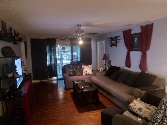 living room featuring ceiling fan and hardwood / wood-style floors