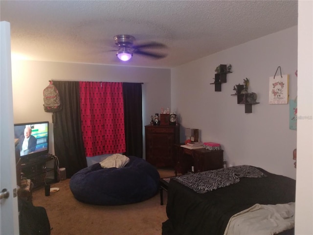 carpeted bedroom featuring ceiling fan and a textured ceiling