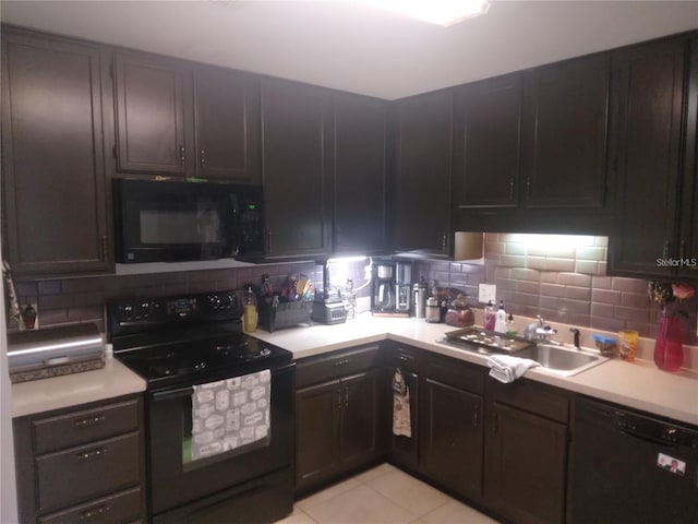 kitchen with dark brown cabinetry, black appliances, sink, backsplash, and light tile patterned flooring