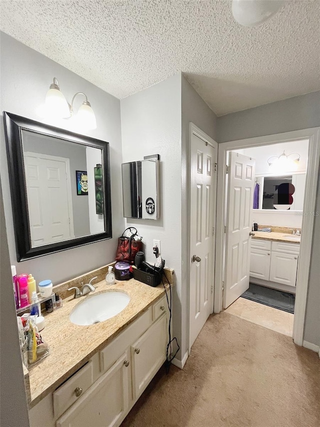 bathroom with a textured ceiling and vanity