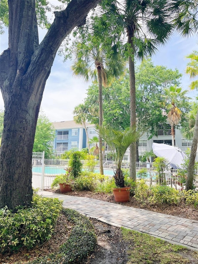 view of property's community featuring fence and a pool