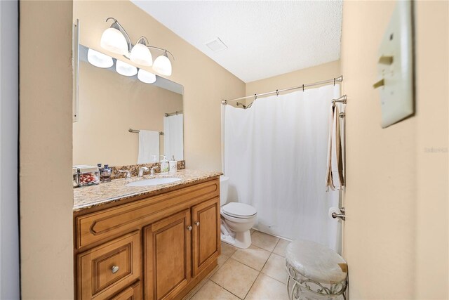 bathroom featuring walk in shower, tile patterned floors, a textured ceiling, toilet, and vanity