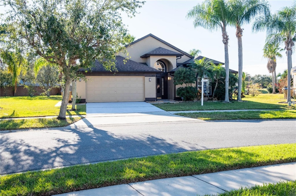 view of front facade with a front lawn and a garage