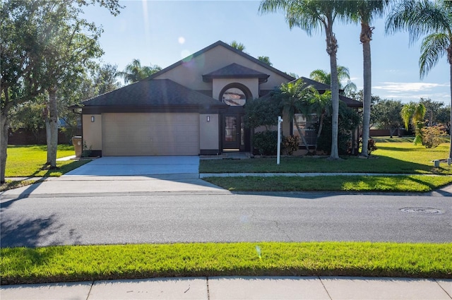 view of front of house featuring a garage and a front lawn