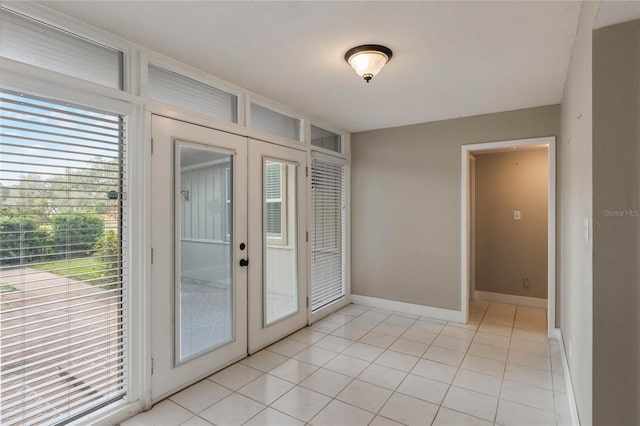 entryway with french doors and light tile patterned floors