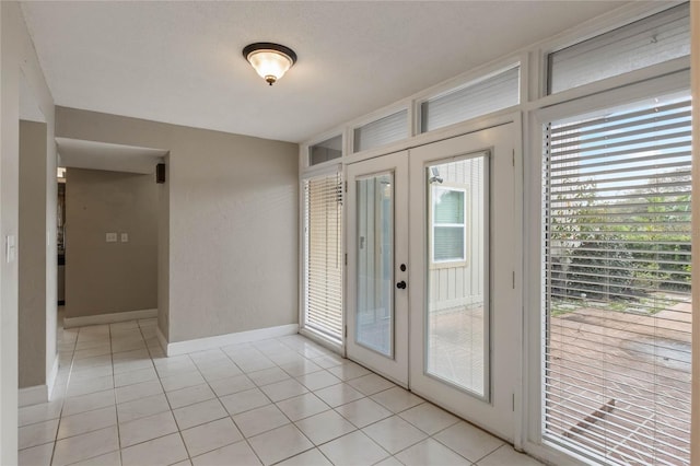 doorway featuring french doors and light tile patterned flooring