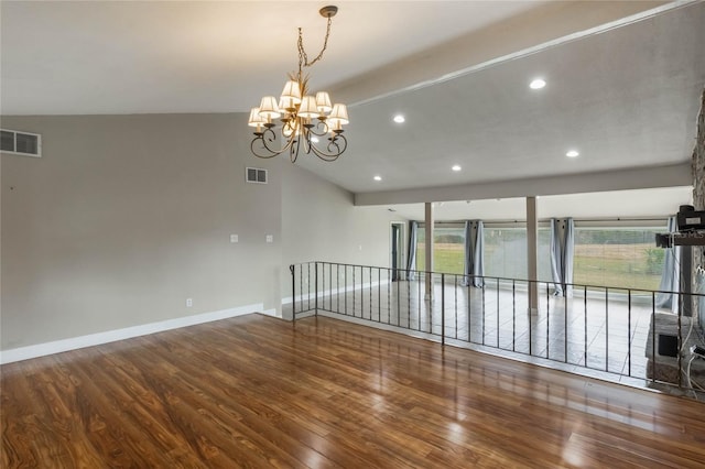 unfurnished room with a stone fireplace, a chandelier, wood-type flooring, and lofted ceiling