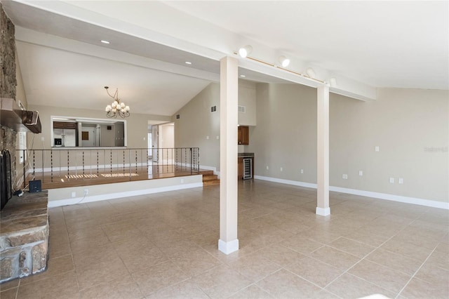 unfurnished living room with vaulted ceiling with beams, light tile patterned floors, a fireplace, and an inviting chandelier