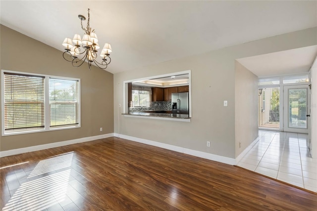 interior space featuring hardwood / wood-style floors, plenty of natural light, and a chandelier