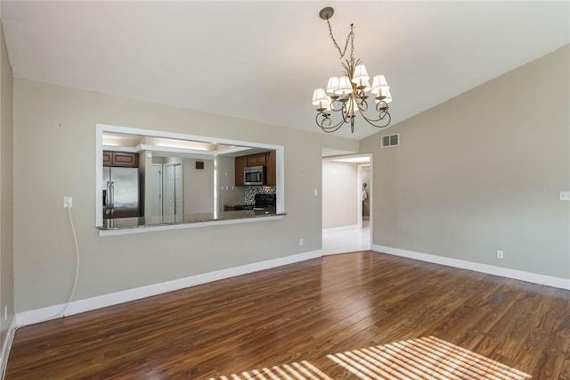 interior space with dark wood-type flooring, a chandelier, and lofted ceiling