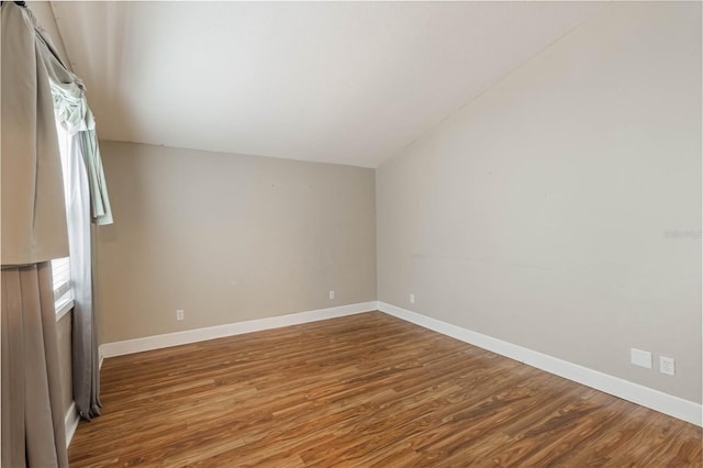 additional living space featuring wood-type flooring and lofted ceiling