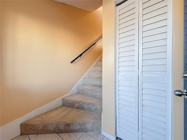 staircase with tile patterned floors