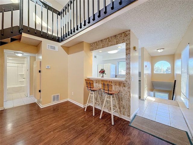 kitchen with hardwood / wood-style floors and a textured ceiling