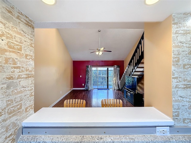 interior space with ceiling fan and dark wood-type flooring