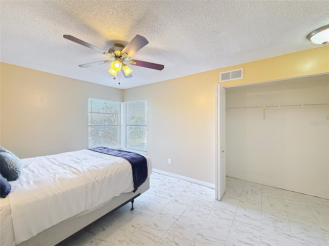 bedroom featuring ceiling fan and a closet