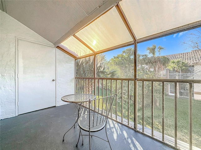 unfurnished sunroom featuring vaulted ceiling and a wealth of natural light