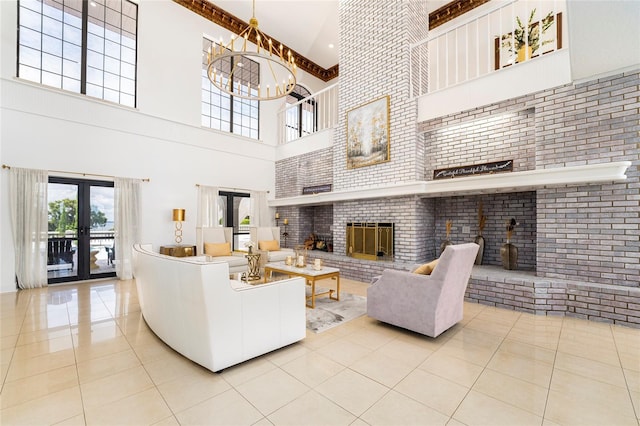 tiled living room featuring french doors, an inviting chandelier, a brick fireplace, brick wall, and a high ceiling