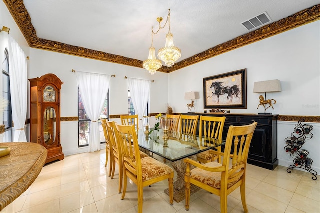 tiled dining area with a chandelier and crown molding