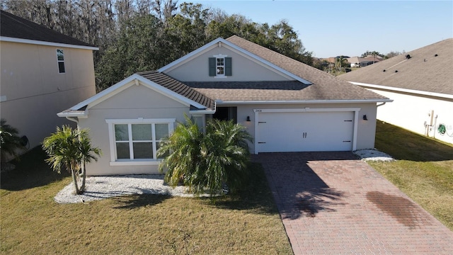 view of front of house featuring a garage and a front lawn