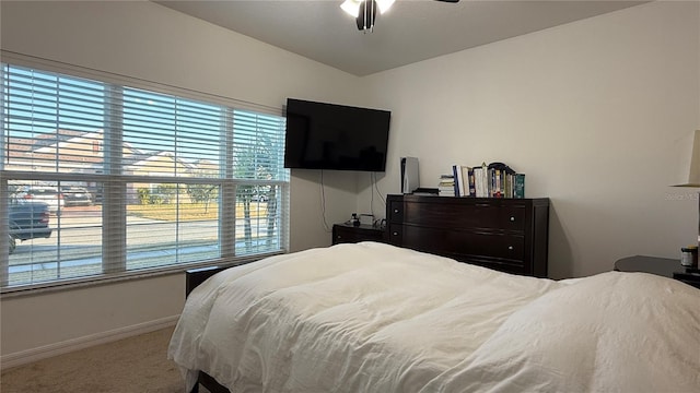 bedroom with multiple windows, carpet, and ceiling fan