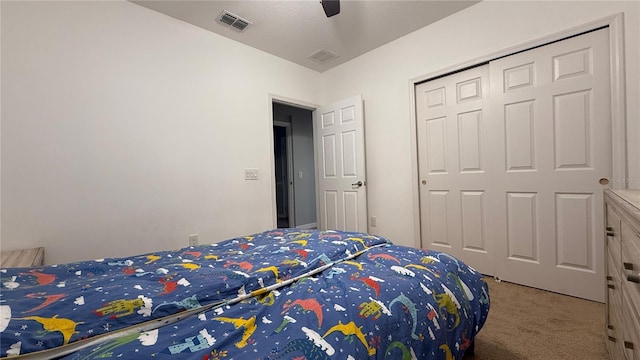 bedroom with carpet, ceiling fan, and a closet