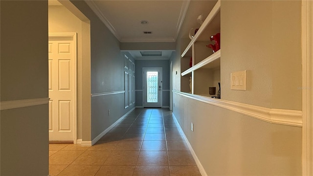 hall with tile patterned flooring and crown molding