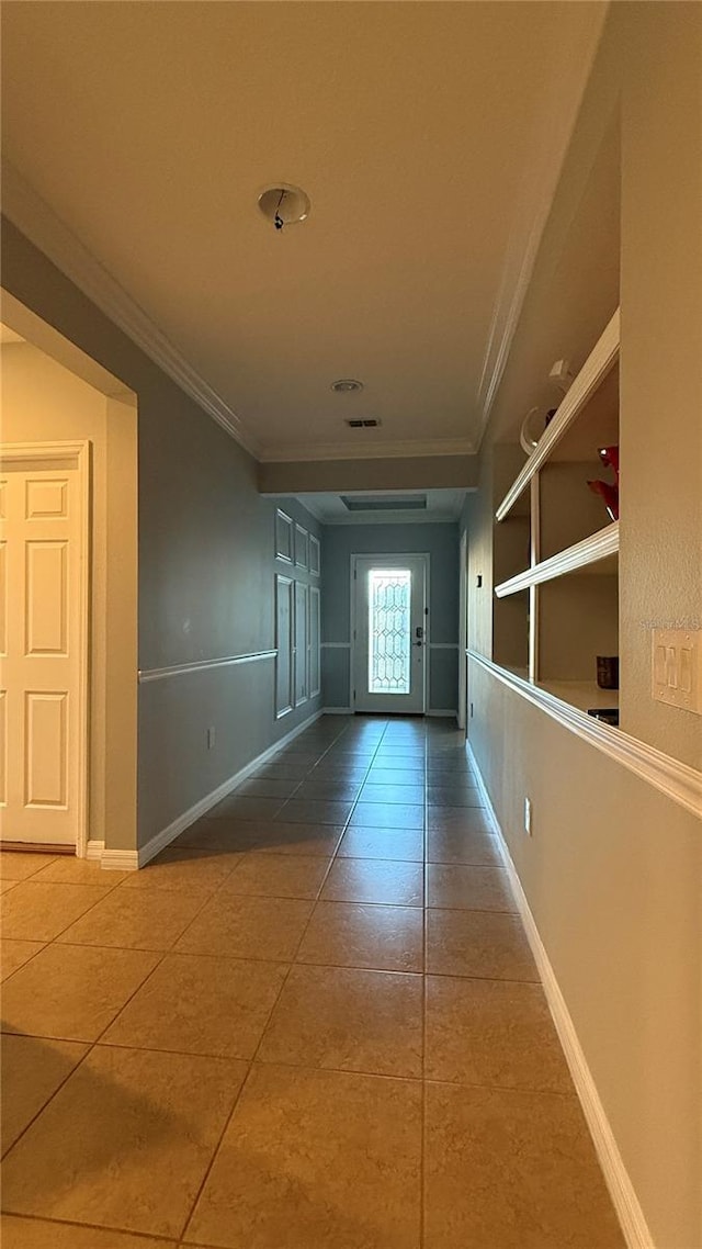 corridor with tile patterned flooring and ornamental molding