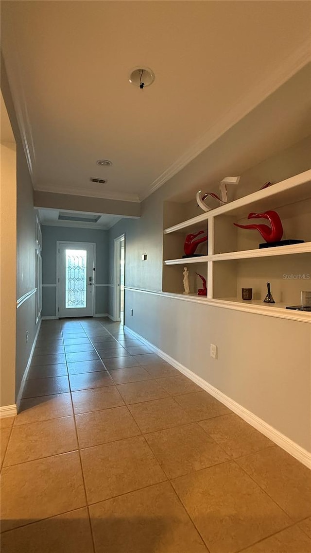 hallway featuring tile patterned flooring, built in features, and crown molding