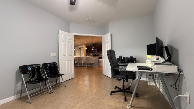 office space featuring ceiling fan and a textured ceiling