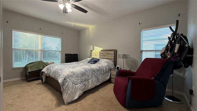 bedroom featuring light colored carpet and ceiling fan