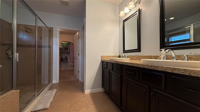 bathroom with tile patterned flooring, vanity, and an enclosed shower