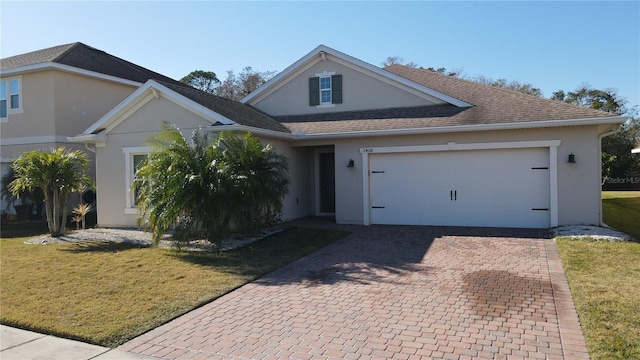 view of front of home with a garage and a front lawn