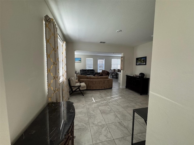 hall with light tile patterned floors