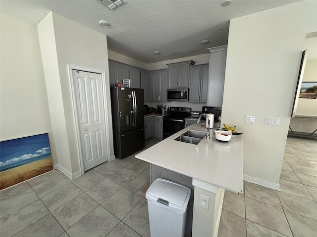 kitchen featuring gray cabinets, sink, kitchen peninsula, and black appliances