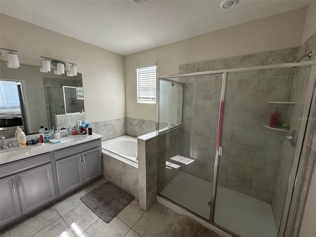 bathroom with independent shower and bath, tile patterned flooring, and vanity