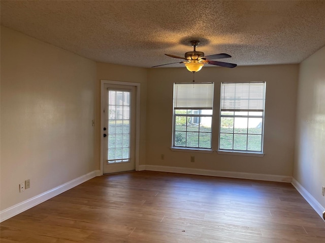 unfurnished room with ceiling fan, hardwood / wood-style floors, and a textured ceiling