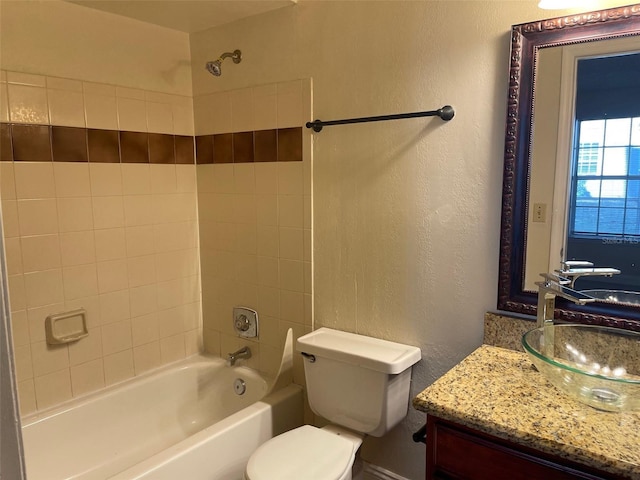 full bathroom with vanity, toilet, and tiled shower / bath