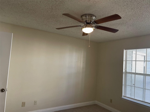 unfurnished room featuring ceiling fan and a textured ceiling