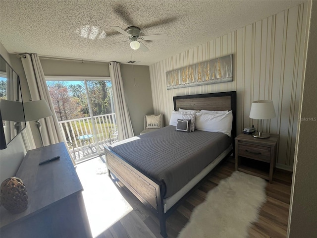 bedroom featuring access to outside, ceiling fan, a textured ceiling, and hardwood / wood-style flooring