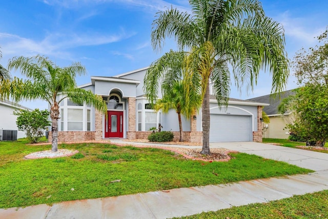 view of front of property with central AC, a front lawn, and a garage