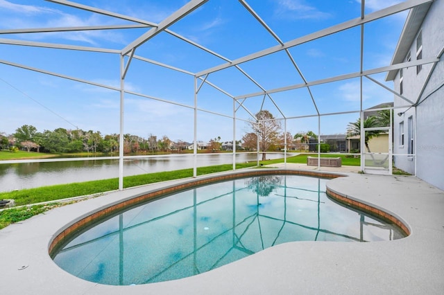 view of pool with glass enclosure and a water view