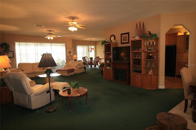 carpeted living room with ceiling fan